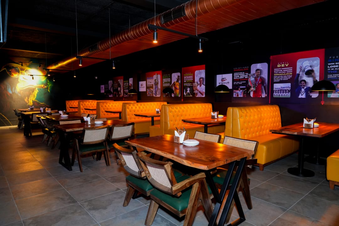 Booth seating beneath sports legend wall posters