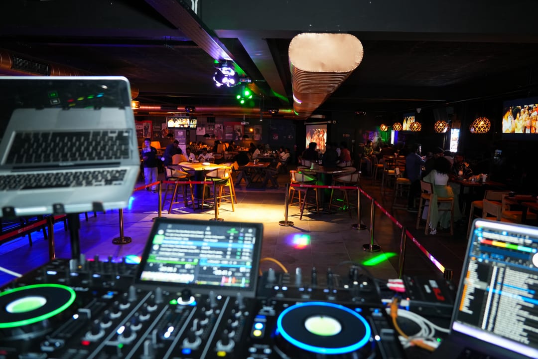 DJ booth view over a lively dining floor