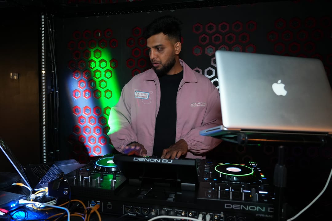 Guest DJ performing live sets on turntables in sports restro-bar lounge