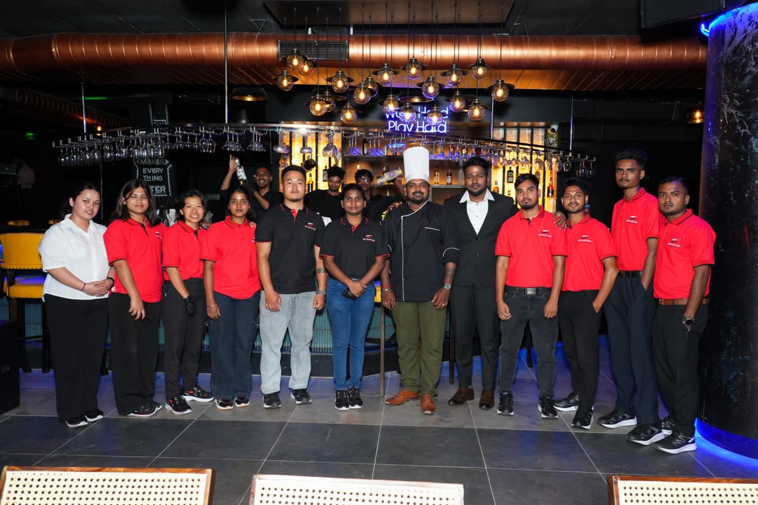 Stadium Sports Bar team and chef posing together at the bar