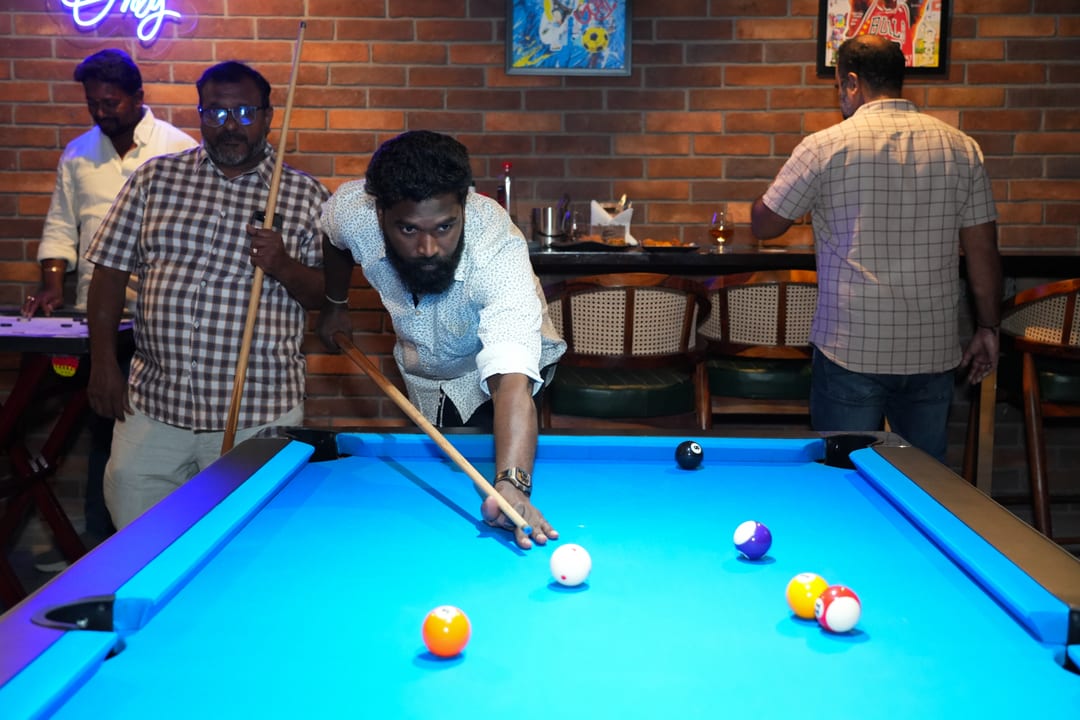 Guest lining up a shot on the pool table