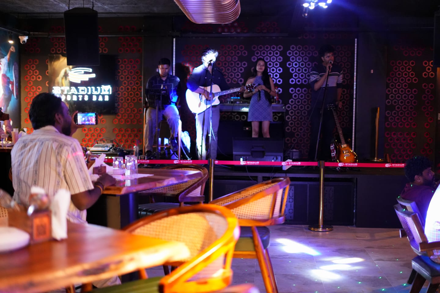 Live Band with Jordan performing acoustic soul in dimly lit restro-bar