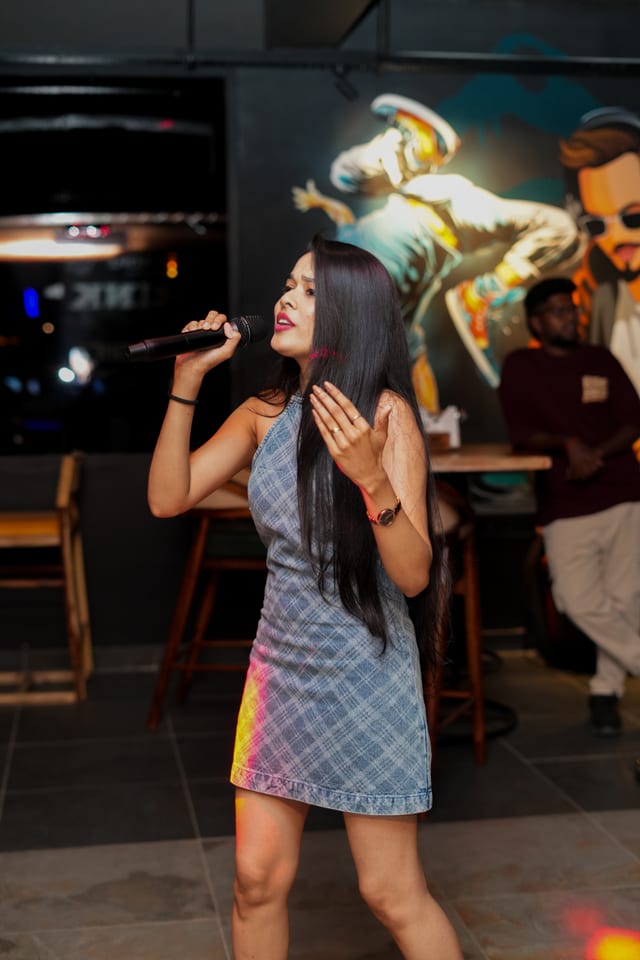 Karaoke Night hosted passionately by artist Pooja Karan on stage