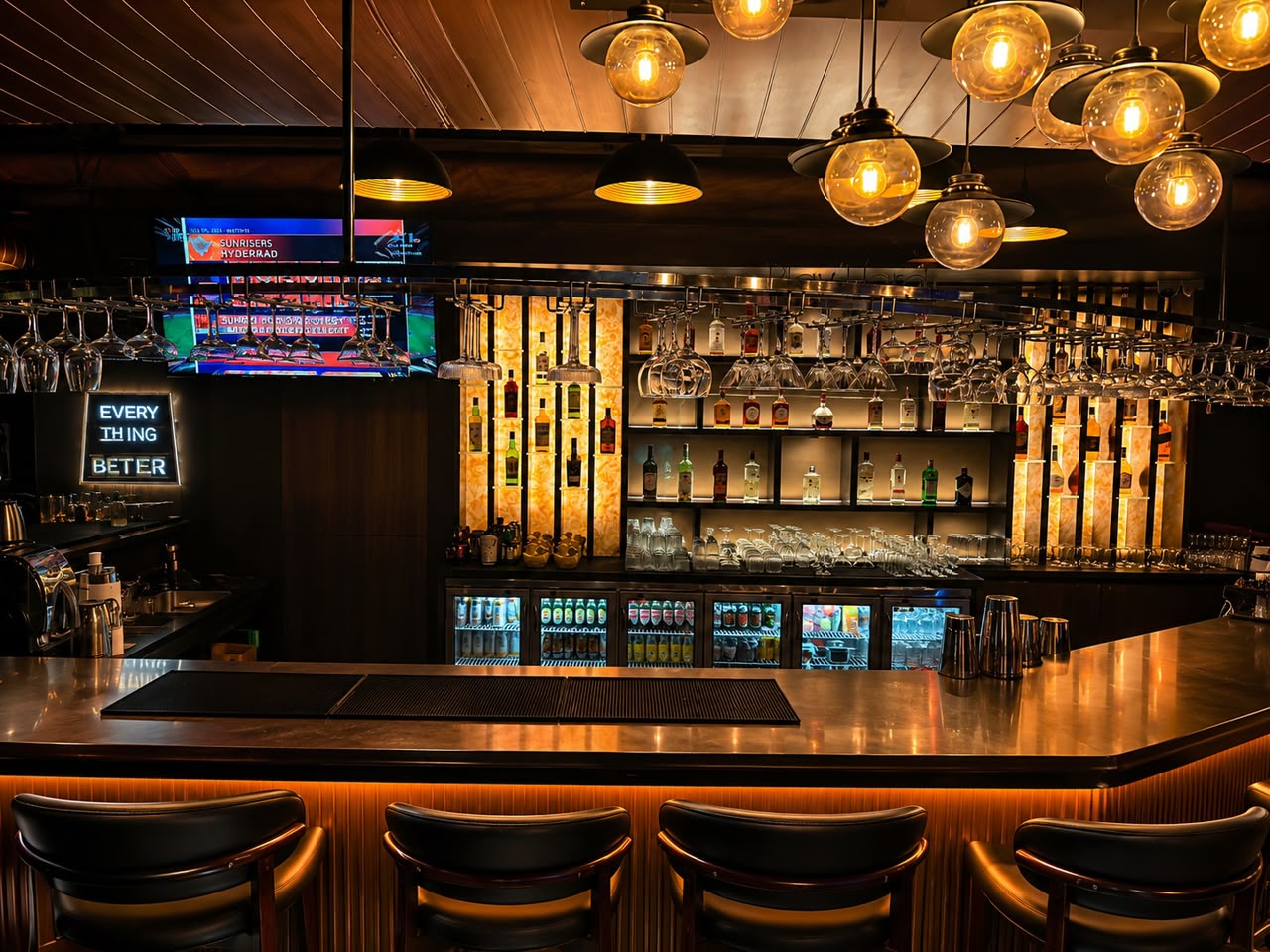Bar seating with sports memorabilia posters and warm lighting